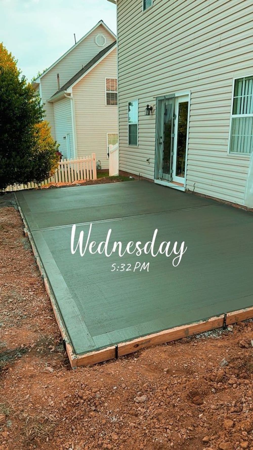 Freshly poured concrete patio beside a house, labeled "Wednesday 5:32 PM."